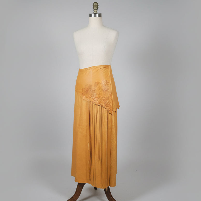 Brown leather shoes with floral patterns on a white surface