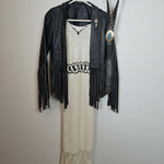 Black fringe bag with decorative elements on a white background