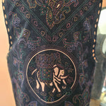 Decorative fabric with intricate patterns and a central design on a plain background