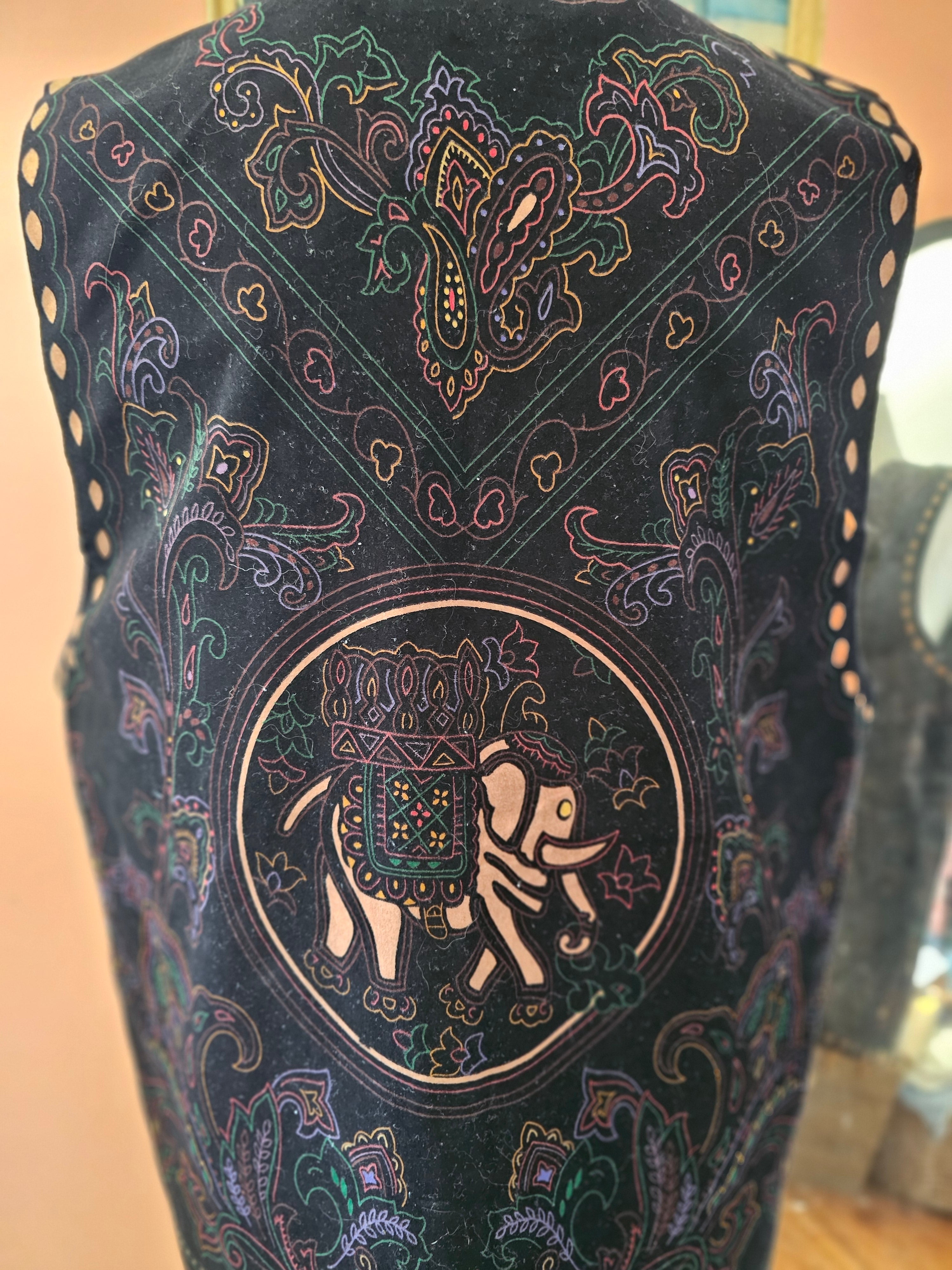 Decorative fabric with intricate patterns and a central design on a plain background