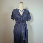 Navy blue dress on a mannequin against a plain background