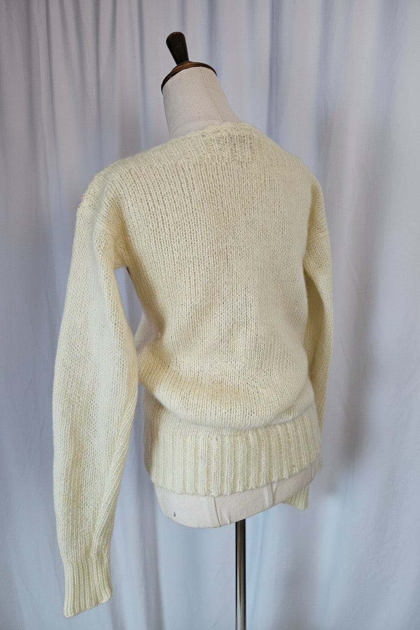 Beige sweater on a mannequin against a neutral background