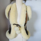White shearling vest with fur trim on a mannequin against a neutral background