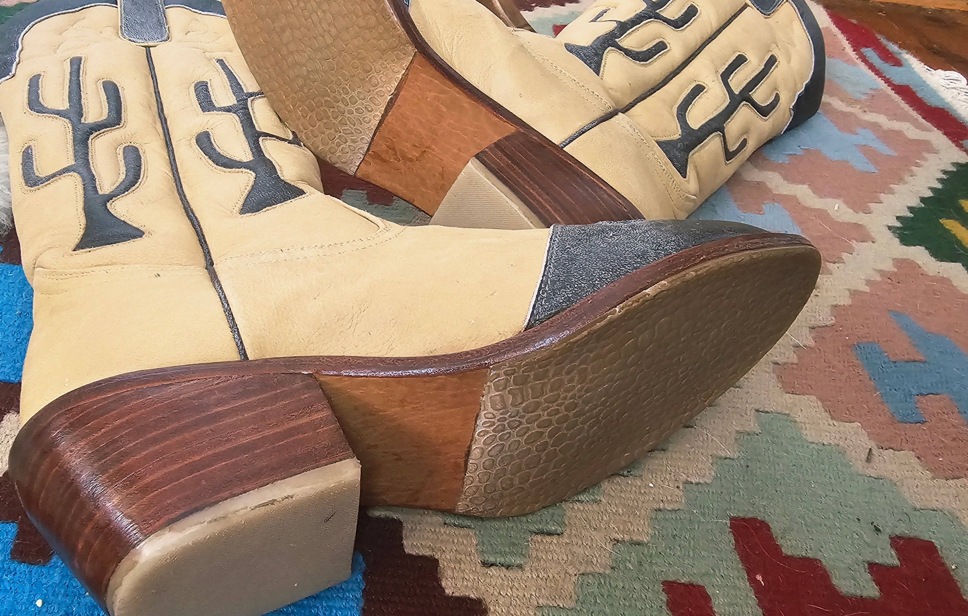 Pair of cowboy boots with wooden soles on a patterned rug