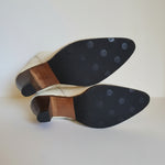 Close-up of a worn shoe sole with a pattern on a textured surface