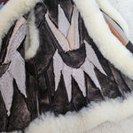 Close-up of a textured fabric with layered patterns in black, white, and gray.