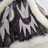 Close-up of a textured fabric with layered patterns in black, white, and gray.