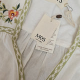 White fabric with green embroidery and floral design, featuring 'MOS' tags.