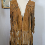 Brown fringed jacket on a mannequin with a plain background
