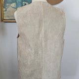 Mannequin wearing a beige dress with a brown hat on a white background