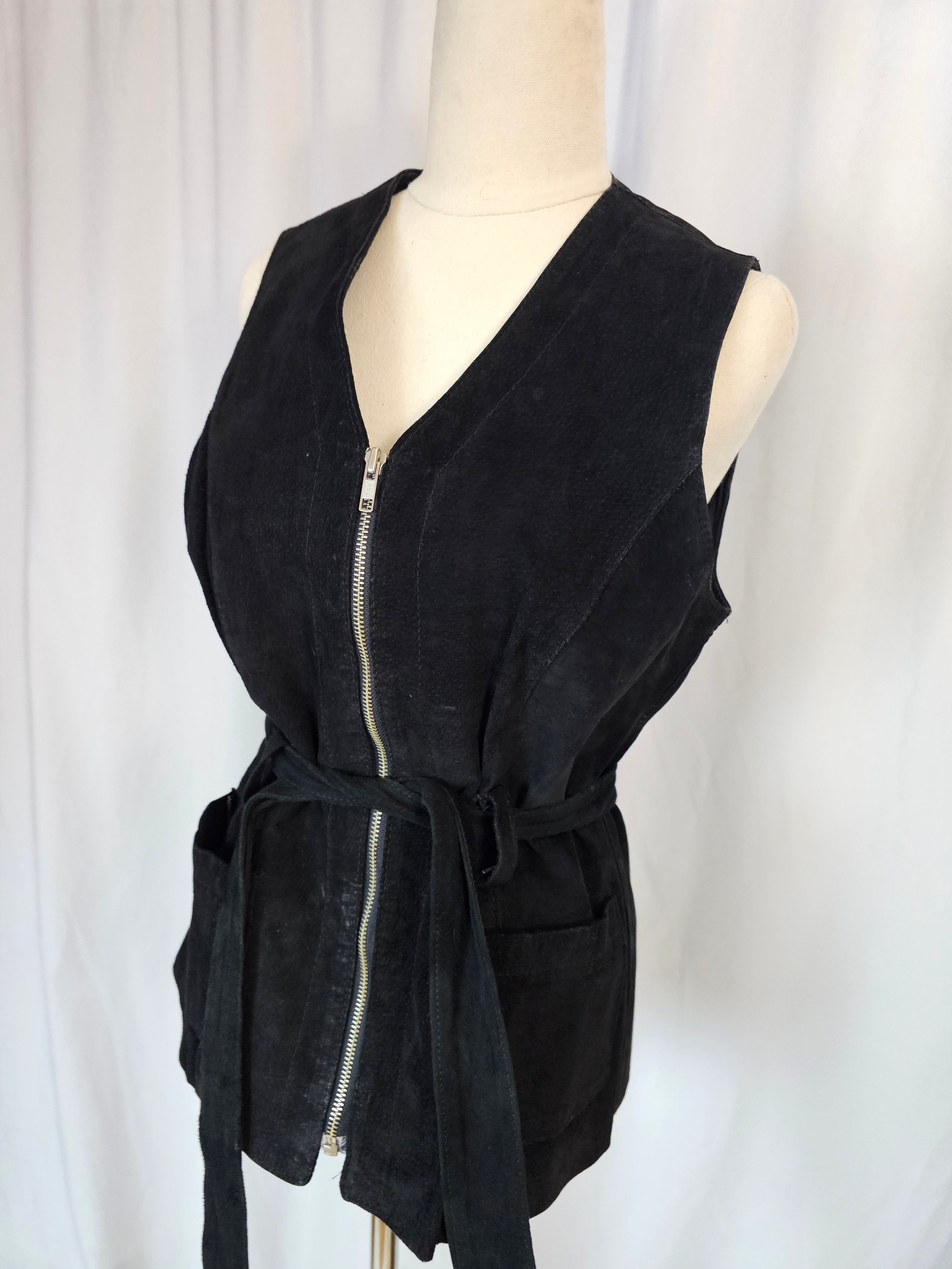 Black dress with zippers on a mannequin against a white background