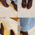 Brown wedge shoes with yellow soles worn with blue jeans on a light background
