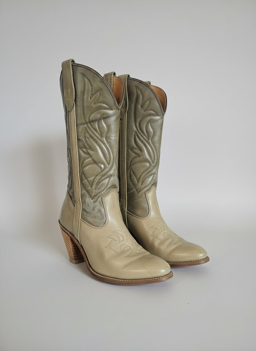 Pair of green leather boots with wooden soles on a white background