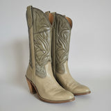 Pair of green leather boots with wooden soles on a white background