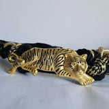 Gold tiger head belt buckle on a white background