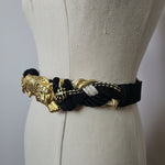 Black and gold braided belt on a mannequin with a plain background