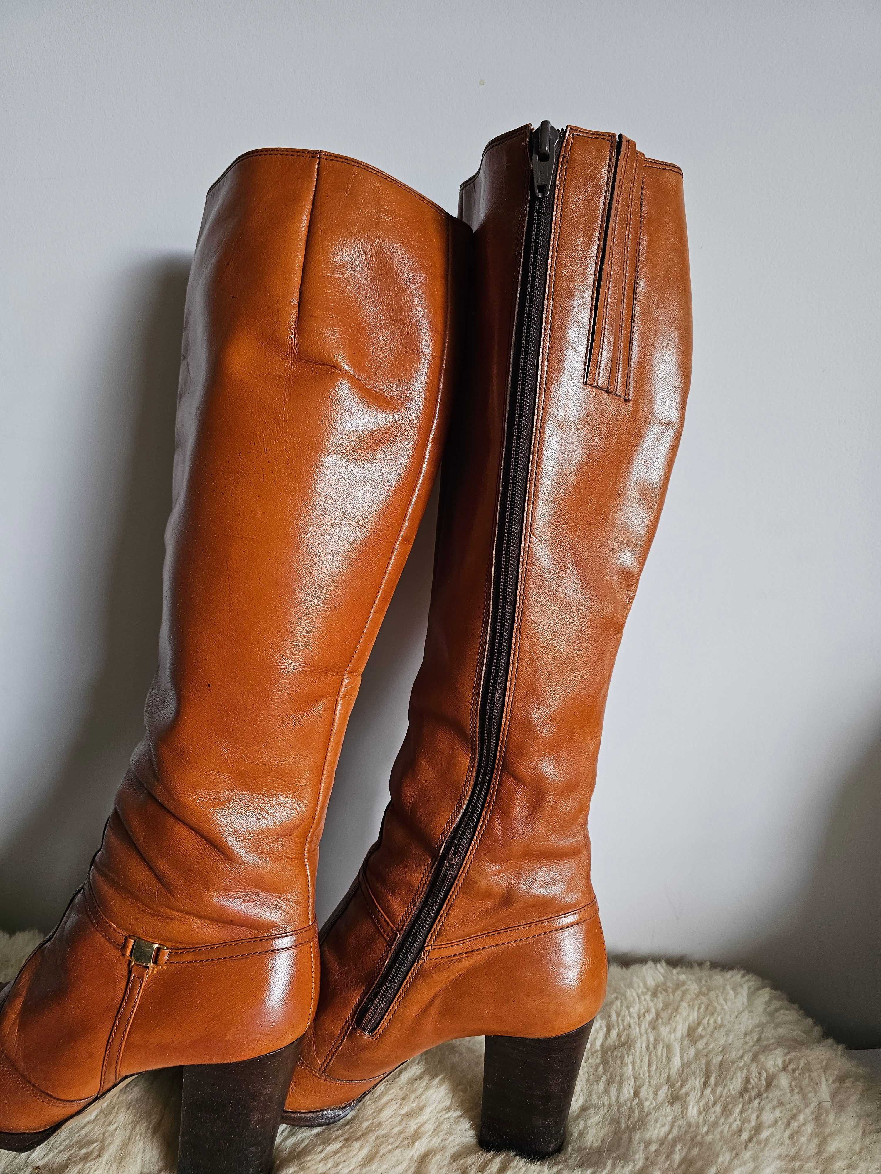 Brown leather boots on a light gray surface