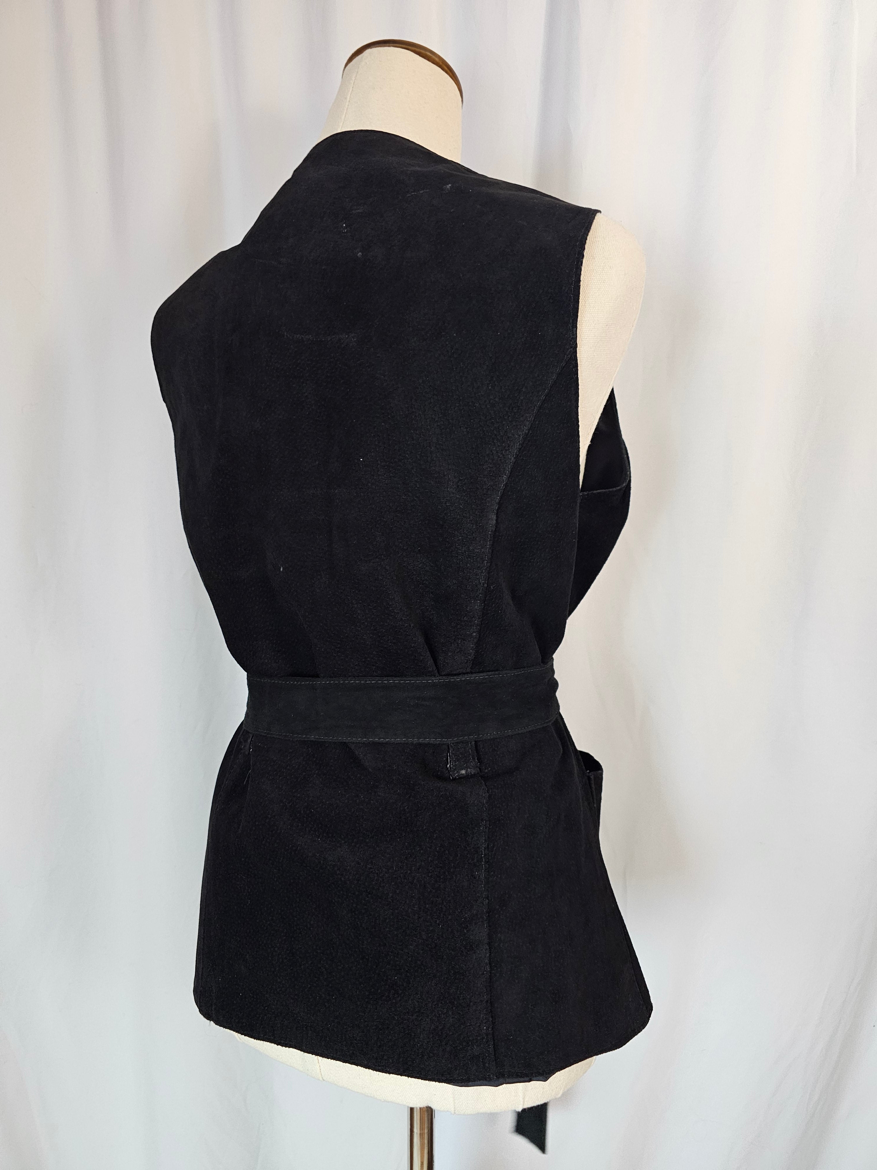 Black strapless top with a large bow on a white background