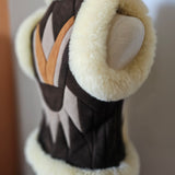 Close-up of a decorative item with a stone on top, set against a blurred background.