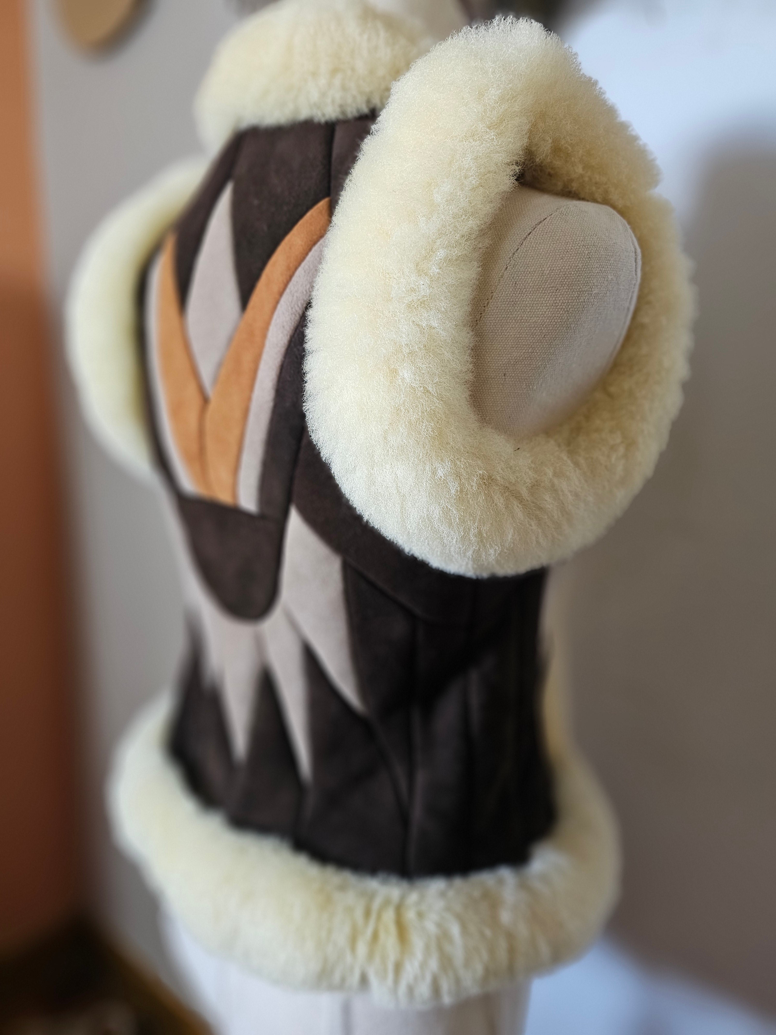 Close-up of a decorative item with a stone on top, set against a blurred background.