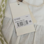 Close-up of a clothing tag with a barcode on a fabric background