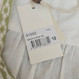 Close-up of a clothing tag with a barcode on a fabric background