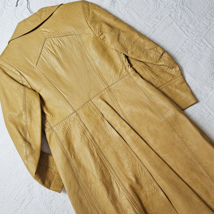 Beige leather jacket on a textured white surface