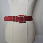 Red bracelet on a white mannequin bust with a plain background