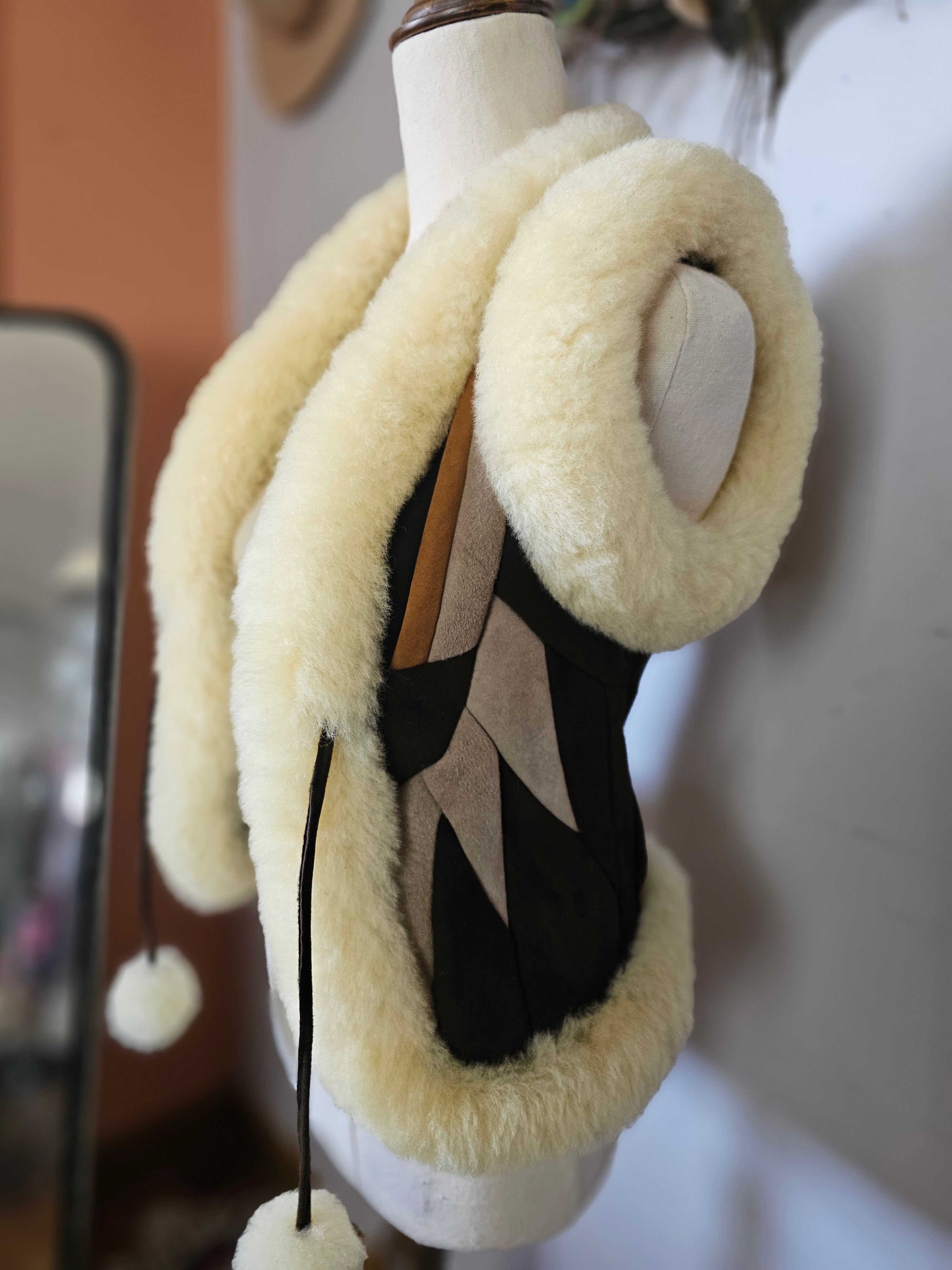 Pair of black shoes with white fuzzy bands on a blurred background