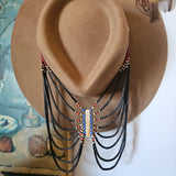Brown cowboy hat with decorative elements on a white background