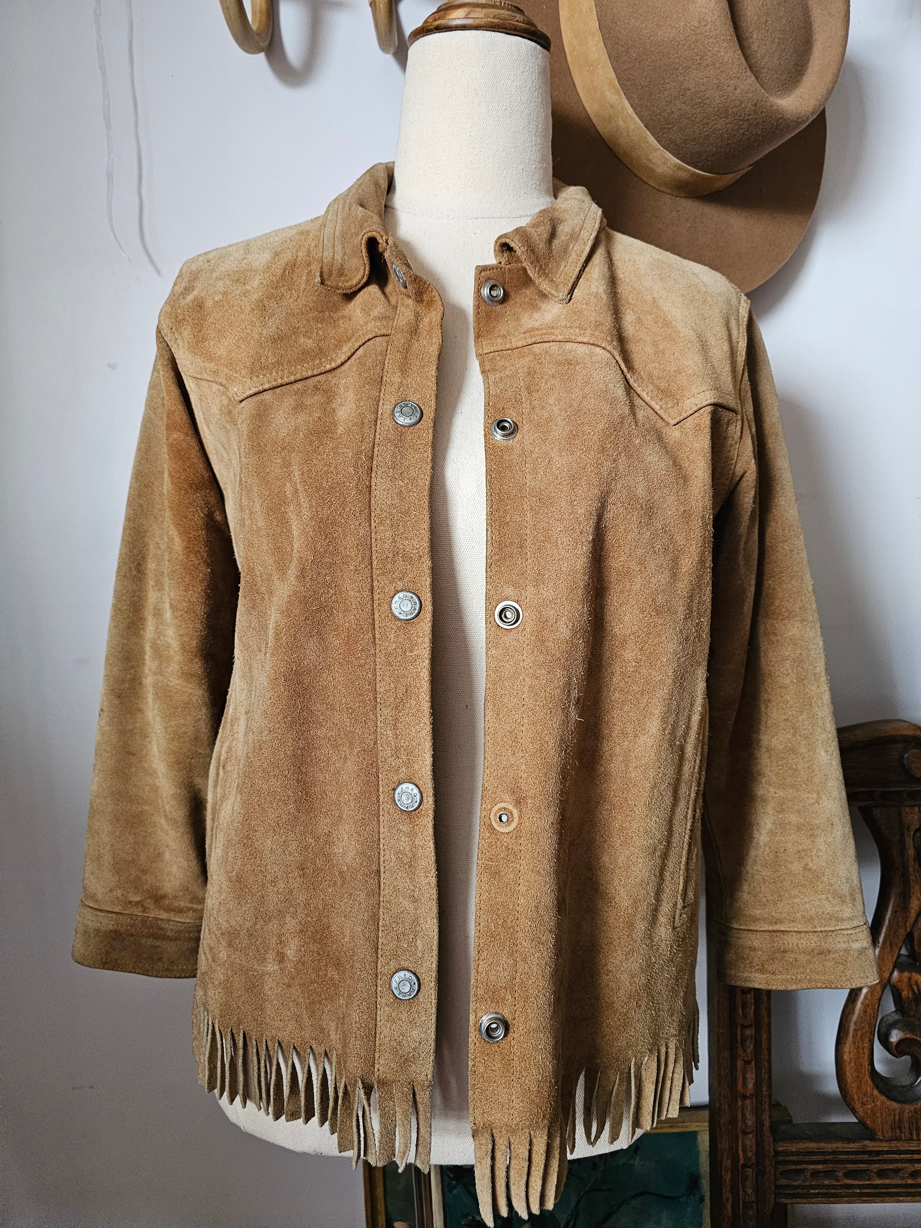 Brown leather jacket with fringes on a white background