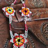 Close-up of a brown leather boot with intricate beadwork on the strap.