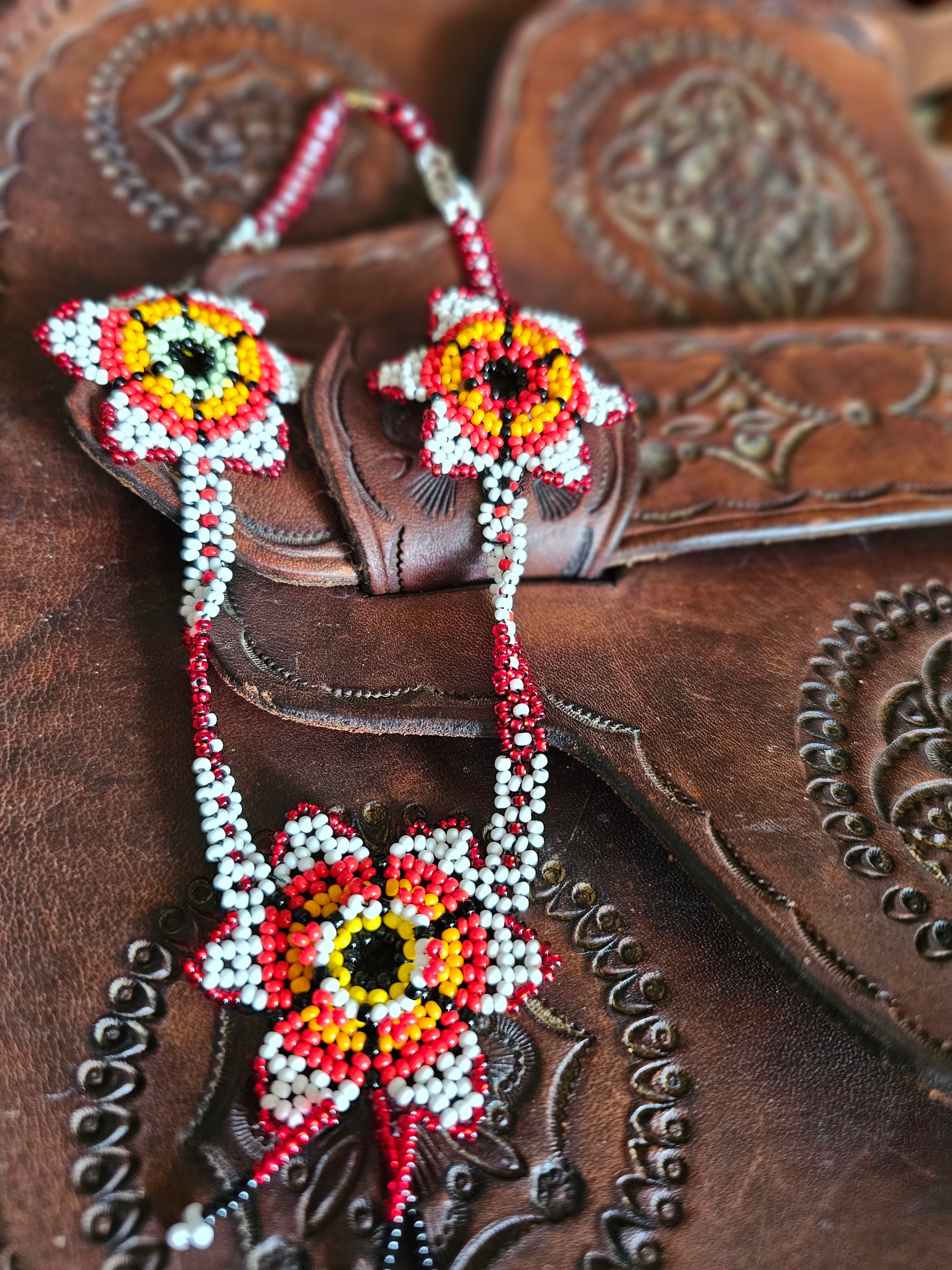 Close-up of a brown leather boot with intricate beadwork on the strap.