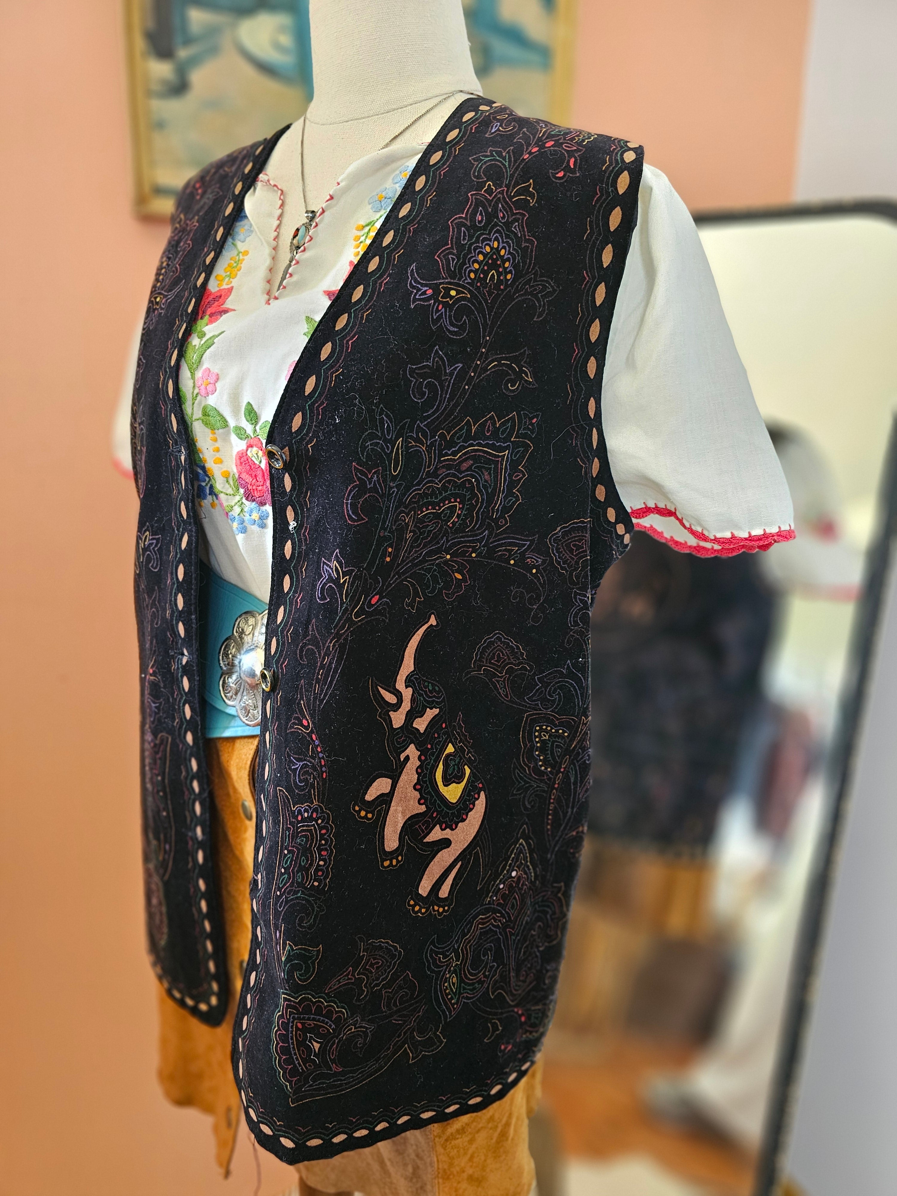 Decorative headband with intricate patterns and a floral fabric layer, worn by a person.