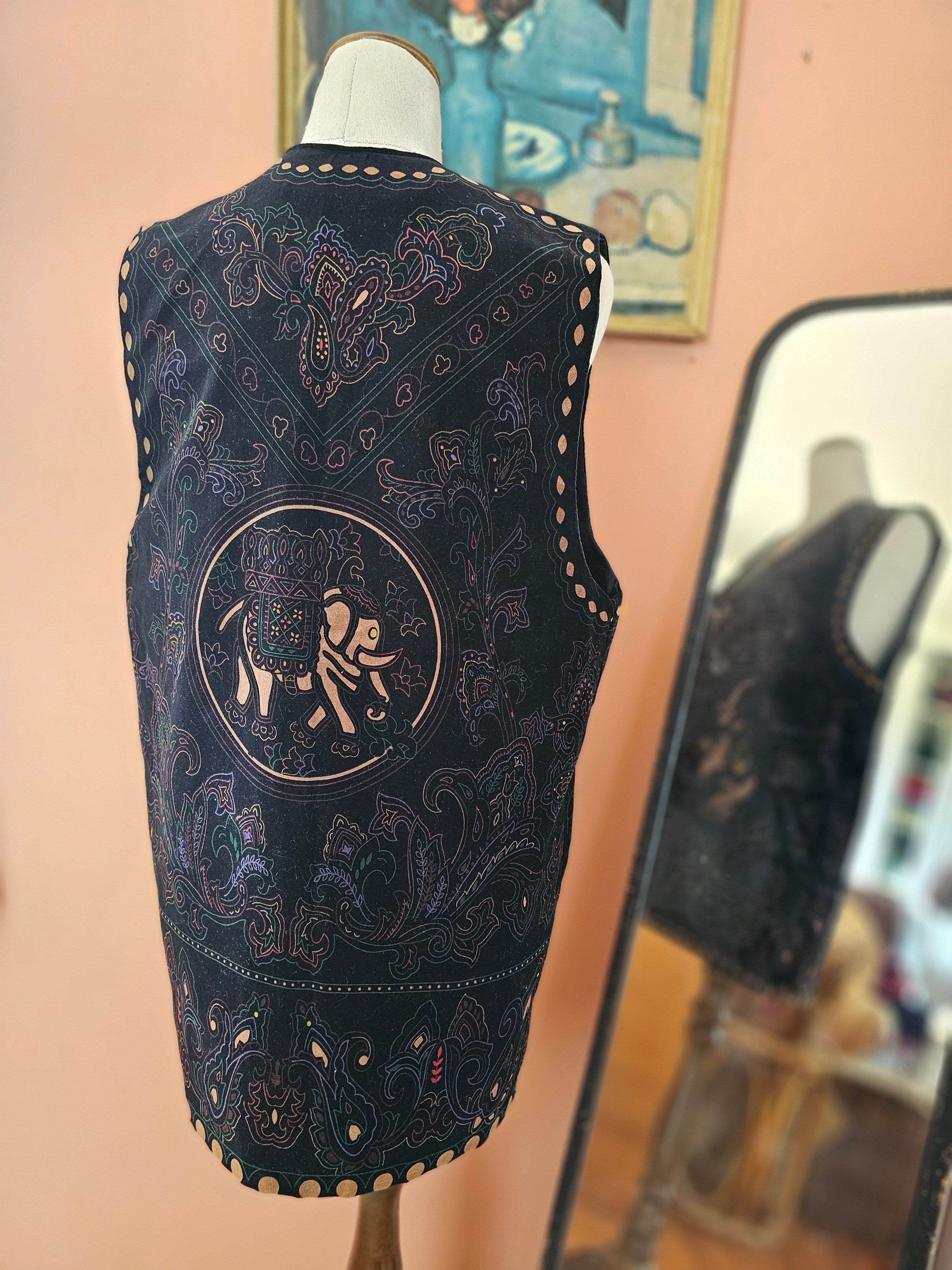 Black embroidered mask with intricate designs on a blurred background