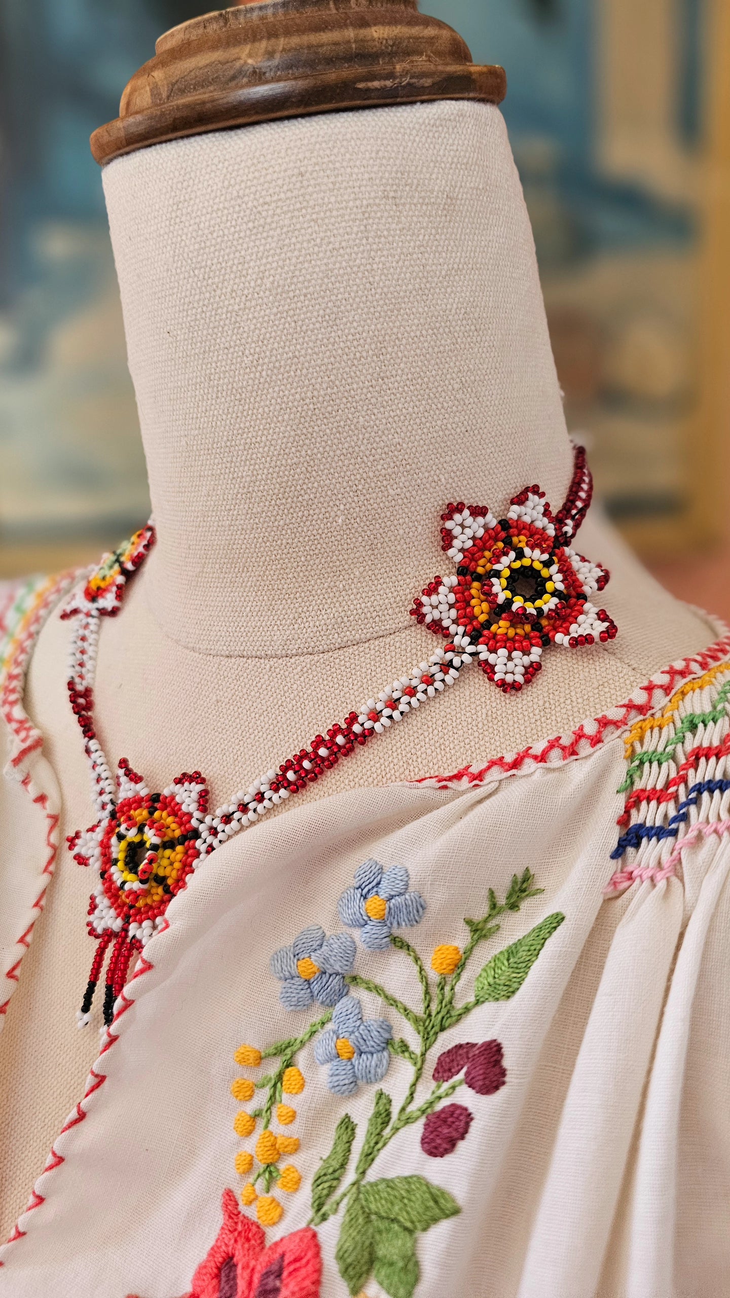 Embroidered garment with floral patterns on a mannequin