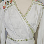 White dress with floral embroidery on a mannequin