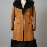 Brown coat with black fur trim on a mannequin against a neutral background