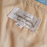 Close-up of a beige fabric with a brand label on a blurred background