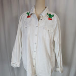 White shirt with embroidery on a mannequin against a plain background