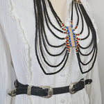 Decorative belt with beads on a white fabric background