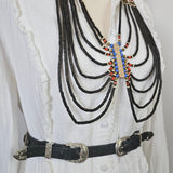 Decorative belt with beads on a white fabric background