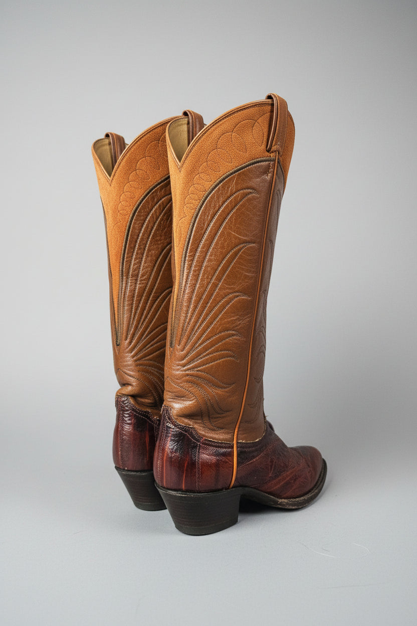 Brown leather saddle with intricate designs on a white background