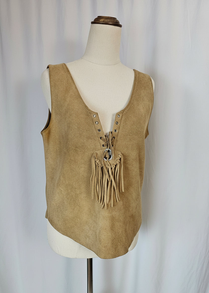 Tan leather saddle with fringes on a mannequin against a neutral background