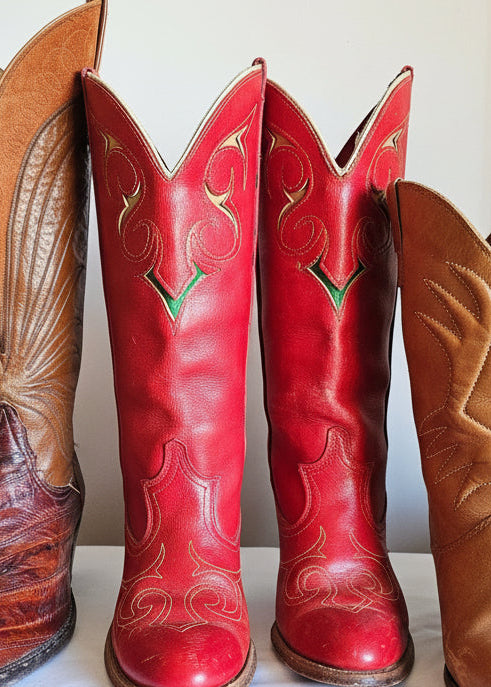 Red and brown cowboy boots with intricate designs on a light background