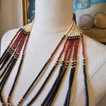 Beaded tassel on a mannequin arm with a blurred background