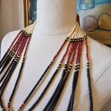 Beaded tassel on a mannequin arm with a blurred background