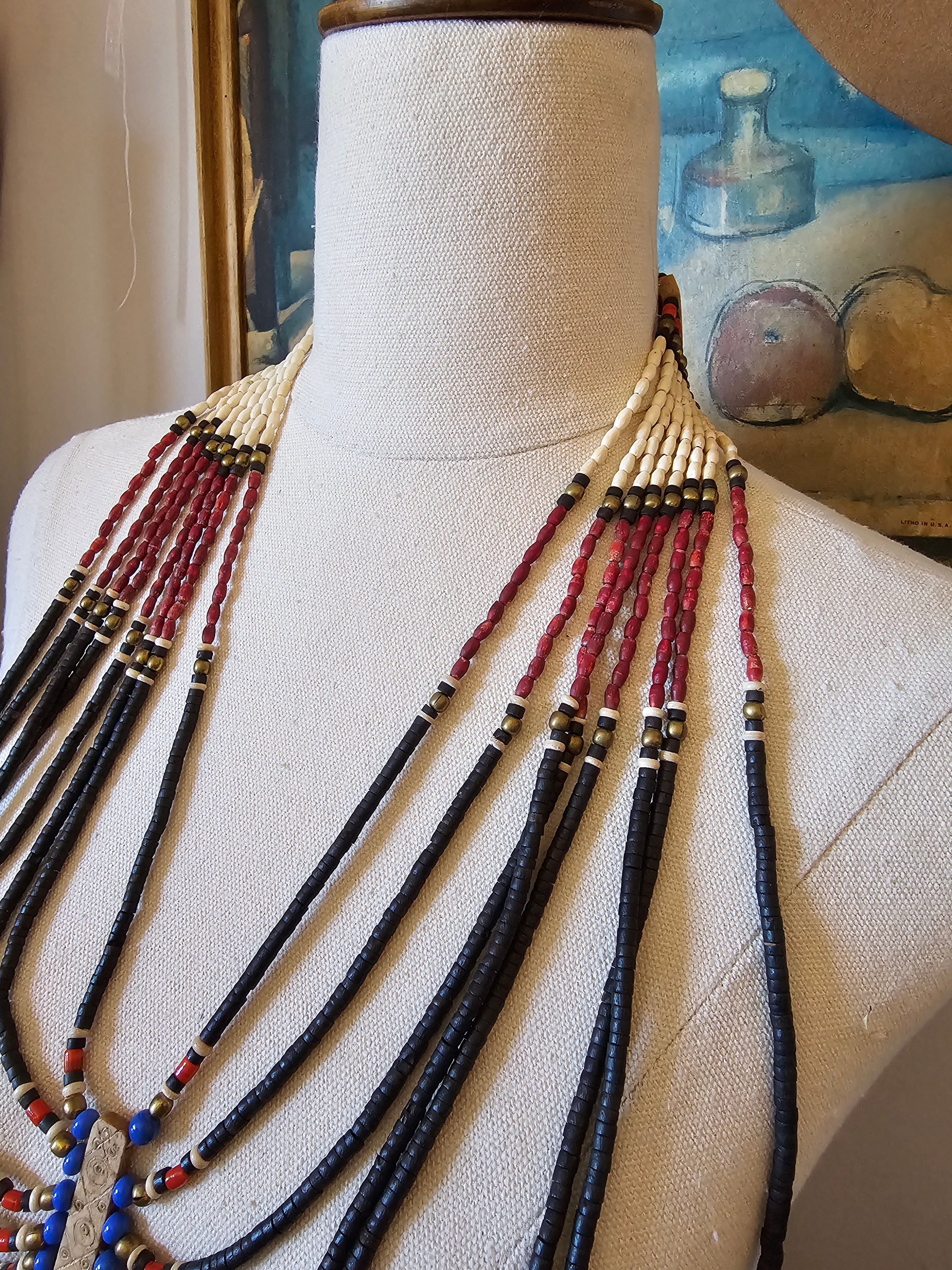 Beaded tassel on a mannequin arm with a blurred background