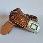 Brown woven belt with a square buckle on a white background