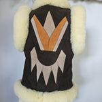 Dog coat with geometric pattern and fur trim on a mannequin against a white background